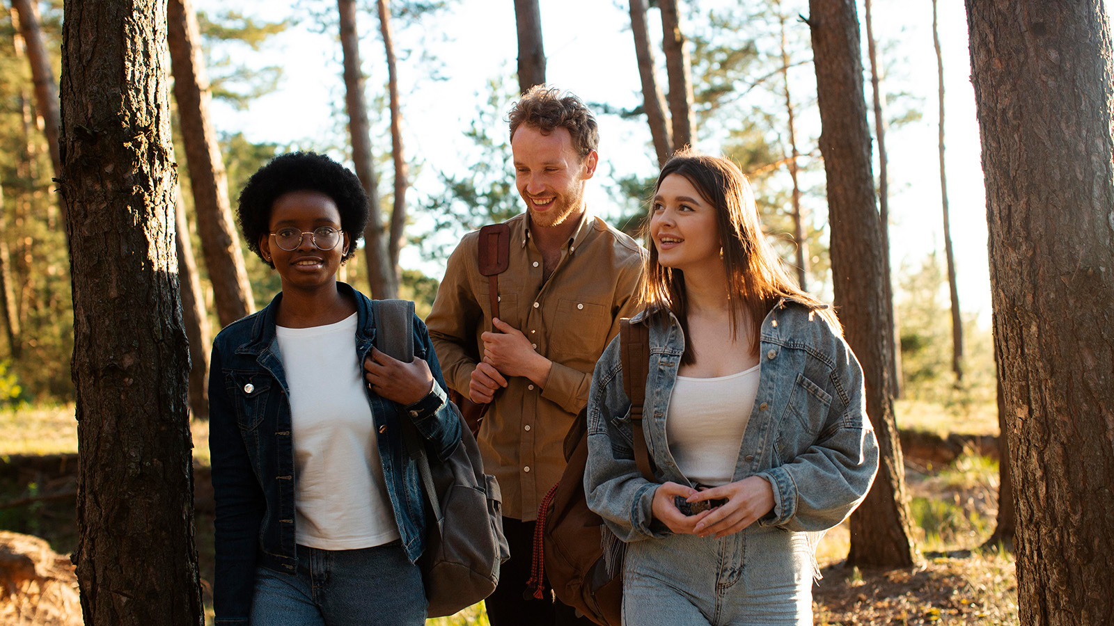 three friends take a walk through a forest