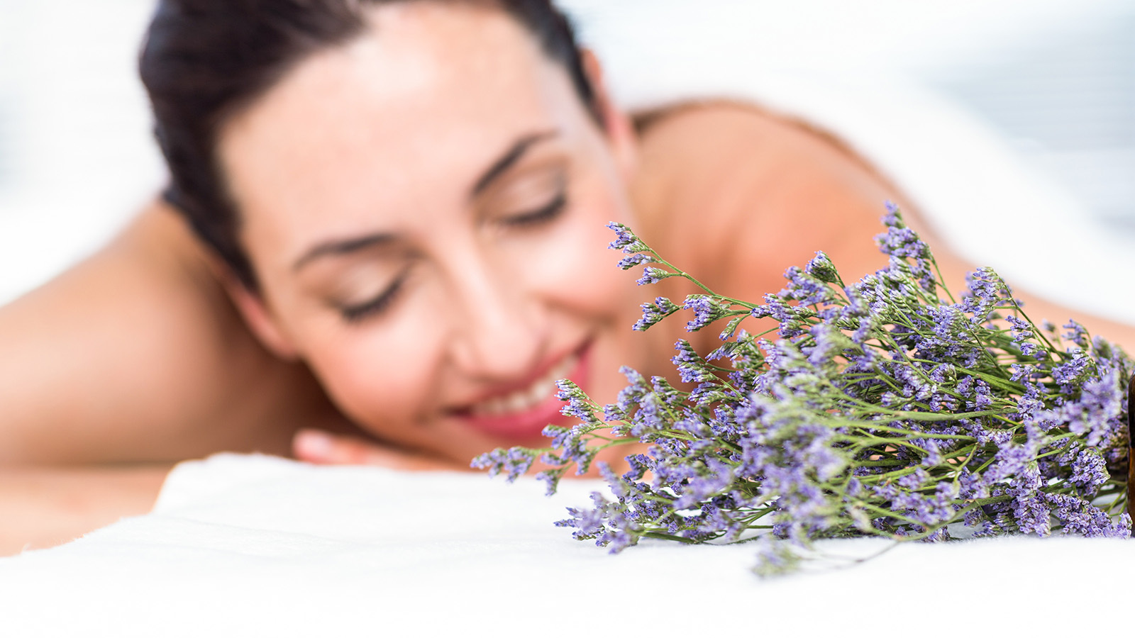 a woman at a spa smelling lavender