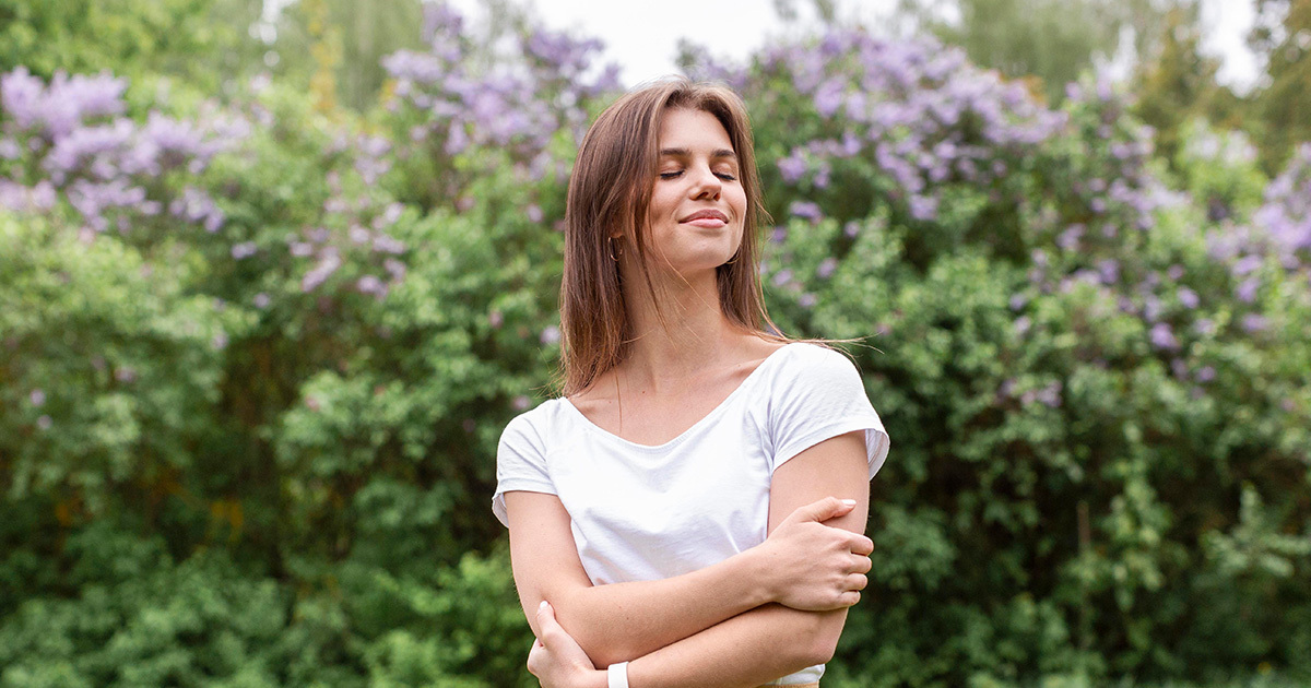 woman standing outdoors smiling